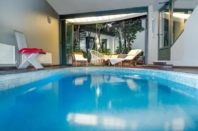 a large blue swimming pool in a house at Kallimarmaro Residence in Athens