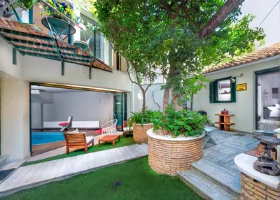 a backyard with a pool and a house at Kallimarmaro Residence in Athens