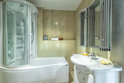 a bathroom with a tub and a sink and a shower at Kallimarmaro Residence in Athens