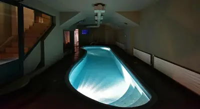 a large blue bath tub in a room with stairs at Kallimarmaro Residence in Athens