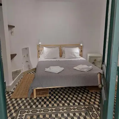 a bedroom with a bed with two towels on it at Kallimarmaro Residence in Athens