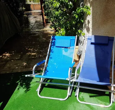 two blue beach chairs sitting next to a building at Athens Glyfada Studio in Athens