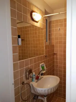 a bathroom with a sink and a mirror at Athens Glyfada Studio in Athens