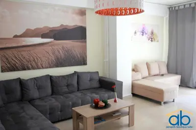 a living room with a couch and a table at Acropolis Boutique Suite in Athens