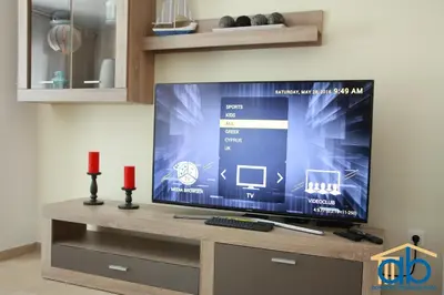 a large flat screen tv sitting on a entertainment center at Acropolis Boutique Suite in Athens