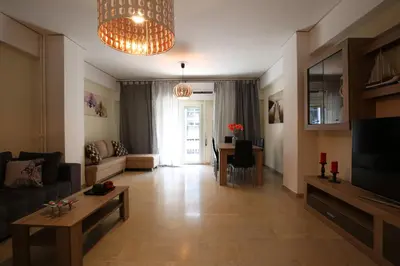 a living room with a couch and a table at Acropolis Boutique Suite in Athens
