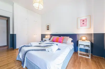 a bedroom with a large bed with towels on it at New Relaxed Central Apartment Walk Everywhere in Athens