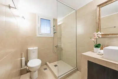 a bathroom with a toilet and a shower and a sink at New Relaxed Central Apartment Walk Everywhere in Athens