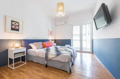 a bedroom with a bed and a flat screen tv at New Relaxed Central Apartment Walk Everywhere in Athens