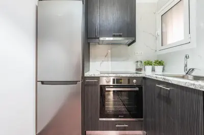 a kitchen with a refrigerator and a sink at New Relaxed Central Apartment Walk Everywhere in Athens
