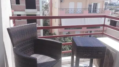 two chairs and a table on a balcony at Feevos in Piraeus