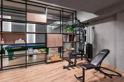 a room with a gym with a chair at 47 Luxury Suites in Athens
