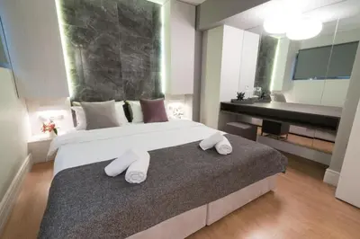 a bedroom with a large bed with white towels on it at 47 Luxury Suites in Athens