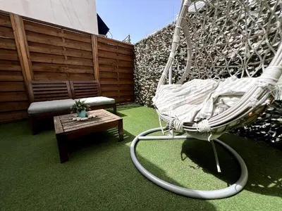 a swinging chair and a bench in a yard at Allure Athens Urban Suites in Athens