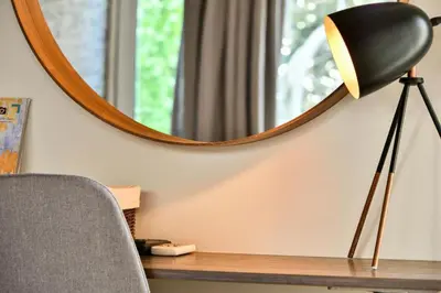 a desk with a lamp and a mirror at Allure Athens Urban Suites in Athens