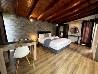 a bedroom with a bed and a table and a desk at Allure Athens Urban Suites in Athens