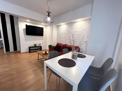 a living room with a white table and chairs at Allure Athens Urban Suites in Athens