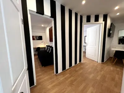 a hallway with a black and white striped wall at Allure Athens Urban Suites in Athens