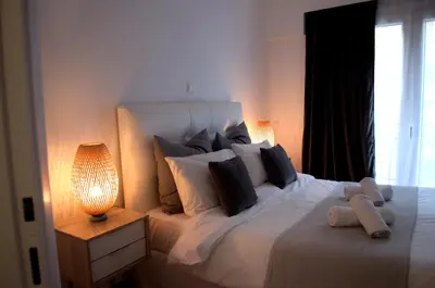 a bedroom with a large white bed with pillows at Allure Athens Urban Suites in Athens