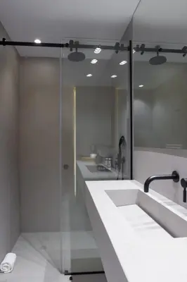 a bathroom with two sinks and a glass shower at SV Acropolis Residence in Athens