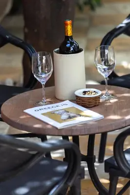 a table with a bottle of wine and two glasses at SV Acropolis Residence in Athens