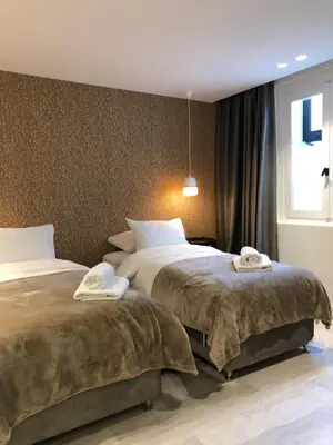 two beds in a hotel room with towels on them at SV Acropolis Residence in Athens