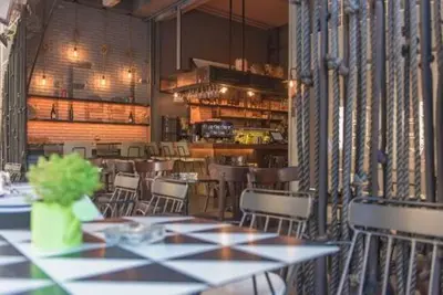 a dining room with tables and chairs in a restaurant at iFeel Athens in Athens