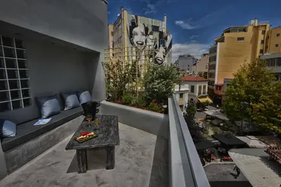 a balcony with a table and a view of a city at iFeel Athens in Athens