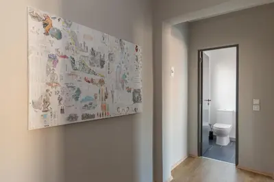 a bathroom with a painting on the wall and a toilet at Amazing Penthouses with Acropolis View in Athens