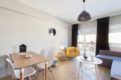 a living room with a table and a couch at Amazing Penthouses with Acropolis View in Athens