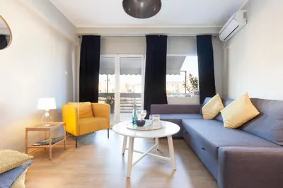 a living room with a couch and a table at Amazing Penthouses with Acropolis View in Athens