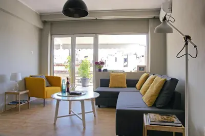 a living room with a couch and a table at Amazing Penthouses with Acropolis View in Athens
