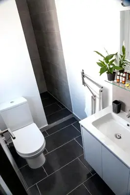 a bathroom with a white toilet and a sink at Amazing Penthouses with Acropolis View in Athens