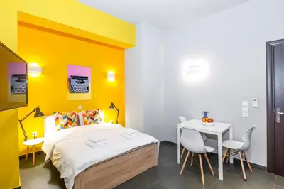 a bedroom with a bed and a table and chairs at Monastiraki Place in Athens