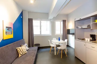a small apartment with a table and a kitchen at Monastiraki Place in Athens