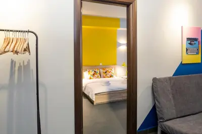 a mirror in a room with a bed and a chair at Monastiraki Place in Athens