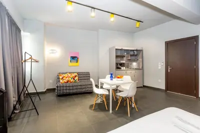 a living room with a table and a chair at Monastiraki Place in Athens