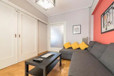 a living room with a couch and a table at Zenios Ippokratis-Comfort & style, Athens downtown in Athens