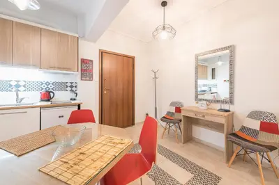 a kitchen and dining room with a table and chairs at Zenios Ippokratis-Comfort & style, Athens downtown in Athens