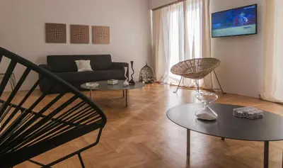 a living room with a couch and two tables at ABA Apartment 2 Vourvachi street in Athens