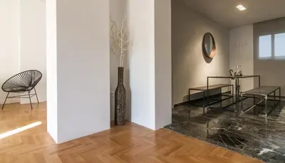 a room with a vase and a table and chairs at ABA Apartment 2 Vourvachi street in Athens