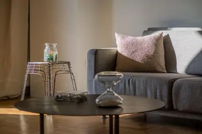 a living room with a couch and a table with an hourglass at ABA Apartment 2 Vourvachi street in Athens