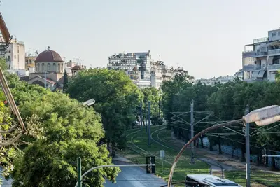 a view of a street with trees and buildings at ABA Apartment 2 Vourvachi street in Athens