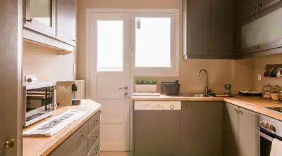 a kitchen with a sink and a window at ABA Apartment 2 Vourvachi street in Athens
