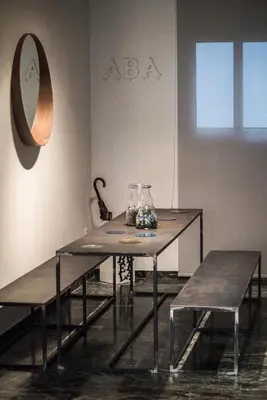 a table and two benches in a room at ABA Apartment 2 Vourvachi street in Athens