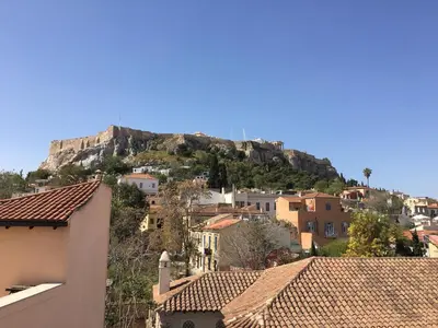 a view of a mountain from the roofs of houses at Best Views of Athens in Athens