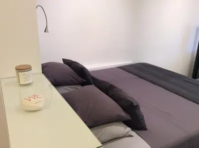 a bedroom with a bed and a table with a cup of coffee at Best Views of Athens in Athens