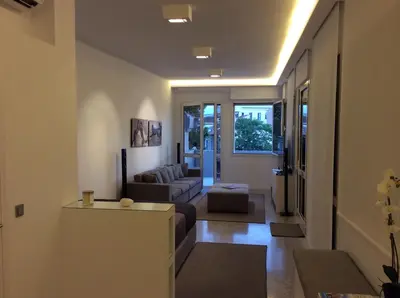 a living room with a couch and a table at Best Views of Athens in Athens
