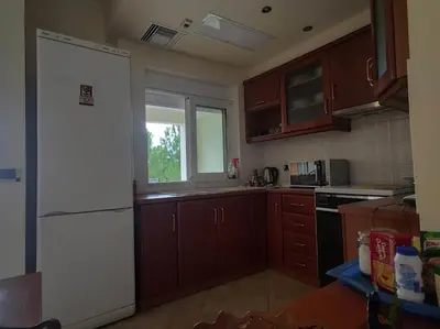 a kitchen with wooden cabinets and a white refrigerator at Private pool & Panorama View on Athens center Hill in Athens