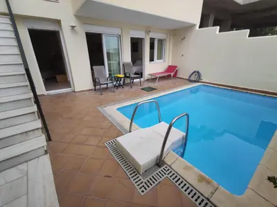 a swimming pool with a patio and a house at Private pool & Panorama View on Athens center Hill in Athens